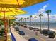 Scenic beach view with palm trees and parked cars at 6302 Pelican Creek Xing # A, St Petersburg, FL 33707