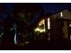 Night view of condo building exterior with landscape lighting illuminating the property at 6302 Pelican Creek Xing # A, St Petersburg, FL 33707