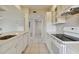 White kitchen with updated appliances and subway tile backsplash at 6302 Pelican Creek Xing # A, St Petersburg, FL 33707