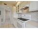 White kitchen with updated appliances and subway tile backsplash at 6302 Pelican Creek Xing # A, St Petersburg, FL 33707