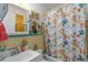 Clean bathroom with a fish-themed shower curtain at 247 93Rd N Ave, St Petersburg, FL 33702
