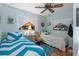 Twin bedroom with light blue walls and wood flooring at 247 93Rd N Ave, St Petersburg, FL 33702