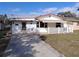 White brick ranch house with a carport and a fenced yard at 247 93Rd N Ave, St Petersburg, FL 33702