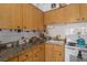 Kitchen features wood cabinets and granite countertops at 247 93Rd N Ave, St Petersburg, FL 33702