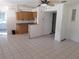 Kitchen with wood cabinets, granite countertops, and tile floor at 247 93Rd N Ave, St Petersburg, FL 33702