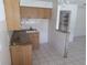 Wood cabinets, granite countertops and tile flooring in kitchen at 247 93Rd N Ave, St Petersburg, FL 33702