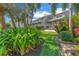 Landscaped backyard with lush greenery and a building at 1375 Pinellas Bayway S # 29, Tierra Verde, FL 33715