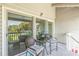 Peaceful balcony with wicker chairs and table overlooking a tranquil outdoor setting at 1375 Pinellas Bayway S # 29, Tierra Verde, FL 33715