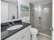 Updated bathroom features granite countertops, a walk-in shower, and white cabinetry at 1375 Pinellas Bayway S # 29, Tierra Verde, FL 33715