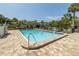 Community pool with lounge chairs and brick pavers at 1375 Pinellas Bayway S # 29, Tierra Verde, FL 33715