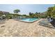 Community pool with lounge chairs and brick pavers at 1375 Pinellas Bayway S # 29, Tierra Verde, FL 33715