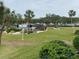 Community pool, patio area, lush landscaping, and waterfront views at 1375 Pinellas Bayway S # 29, Tierra Verde, FL 33715