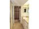 Well-lit bathroom featuring double vanity, walk-in shower with tile surround, and ample storage space at 1806 Mariner Dr # 214, Tarpon Springs, FL 34689