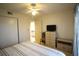 Bright bedroom with a striped comforter, and neutral walls at 1806 Mariner Dr # 214, Tarpon Springs, FL 34689