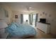 Bright bedroom featuring a ceiling fan, an exterior door, and multiple windows with natural light at 1806 Mariner Dr # 214, Tarpon Springs, FL 34689