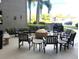 Community outdoor seating area with tables, chairs and fire pit at 1806 Mariner Dr # 214, Tarpon Springs, FL 34689