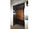 Modern stainless steel elevator with wood paneled walls at 1806 Mariner Dr # 214, Tarpon Springs, FL 34689