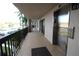 Hallway exterior view of building with elevator and palm tree views at 1806 Mariner Dr # 214, Tarpon Springs, FL 34689