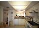 Bright kitchen featuring a functional layout, white cabinets, modern appliances, and a pass-through to dining at 1806 Mariner Dr # 214, Tarpon Springs, FL 34689