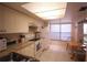 Well-lit kitchen features ample cabinet space, a breakfast table, and white appliances at 1806 Mariner Dr # 214, Tarpon Springs, FL 34689