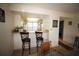 Kitchen view from dining area with white cabinetry, neutral countertops, and convenient breakfast bar seating at 1806 Mariner Dr # 214, Tarpon Springs, FL 34689