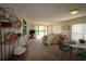 Open-concept living room with plush carpeting, sliding doors, and a separate dining area at 1806 Mariner Dr # 214, Tarpon Springs, FL 34689