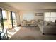 Bright living room area with natural light, comfortable seating, and balcony access at 1806 Mariner Dr # 214, Tarpon Springs, FL 34689