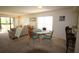 Bright living room featuring neutral tones, a comfortable sofa, and a dining area with seating at 1806 Mariner Dr # 214, Tarpon Springs, FL 34689