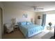 Bright main bedroom boasts a ceiling fan and a comfortable seating area by the window at 1806 Mariner Dr # 214, Tarpon Springs, FL 34689