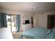 Bright main bedroom with slider access to a private patio, and ensuite bathroom at 1806 Mariner Dr # 214, Tarpon Springs, FL 34689