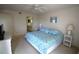 Bright main bedroom boasts a ceiling fan and ensuite bathroom at 1806 Mariner Dr # 214, Tarpon Springs, FL 34689