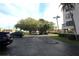 A parking area with mature trees provides shade and privacy, located in the beautiful condo community near the marina at 1806 Mariner Dr # 214, Tarpon Springs, FL 34689