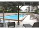 A community pool with comfortable lounge chairs and a covered patio providing shade and relaxation at 1806 Mariner Dr # 214, Tarpon Springs, FL 34689