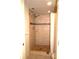 Walk-in shower with glass door, tile surround, built-in shelving, shower head, and mosaic accents at 1806 Mariner Dr # 214, Tarpon Springs, FL 34689