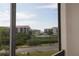 Scenic view from balcony featuring a pond and the complex buildings in a well-maintained community at 1806 Mariner Dr # 214, Tarpon Springs, FL 34689