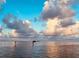 Calm water reflecting a blue sky with fluffy clouds over the water at 1806 Mariner Dr # 214, Tarpon Springs, FL 34689