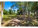 Large backyard with mature trees and grass at 9660 90Th Ave, Seminole, FL 33777