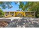 Beautiful yellow house with a large front porch and mature landscaping at 9660 90Th Ave, Seminole, FL 33777