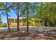 Exterior of a charming, two-story yellow home with balconies and ample landscaping at 9660 90Th Ave, Seminole, FL 33777