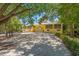 Front view of a two-story house with a long driveway at 9660 90Th Ave, Seminole, FL 33777