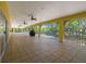 Extended screened-in porch with a view of the trees at 9660 90Th Ave, Seminole, FL 33777