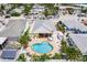 Aerial view of a charming home with a heart-shaped pool and lush landscaping at 108 11Th Ave, St Pete Beach, FL 33706