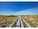 Wooden walkway leading to a beautiful beach at 108 11Th Ave, St Pete Beach, FL 33706