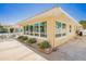 Side exterior view showcasing large windows and landscaping at 108 11Th Ave, St Pete Beach, FL 33706