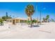 Cute yellow beach cottage with white fence and palm trees at 108 11Th Ave, St Pete Beach, FL 33706