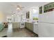 A galley-style kitchen with green cabinets and white appliances at 108 11Th Ave, St Pete Beach, FL 33706