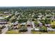 Aerial view of the red apartment complex, showing the pool, parking lot and surrounding trees at 8221 12Th N Way # F, St Petersburg, FL 33702