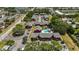 An aerial view shows a red brick apartment complex with a swimming pool and ample parking at 8221 12Th N Way # F, St Petersburg, FL 33702