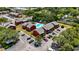 Aerial view of the red apartment complex with a swimming pool, parking lot and green landscaping at 8221 12Th N Way # F, St Petersburg, FL 33702