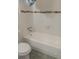 A bathroom features a tub with tile surround and a standard toilet at 8221 12Th N Way # F, St Petersburg, FL 33702